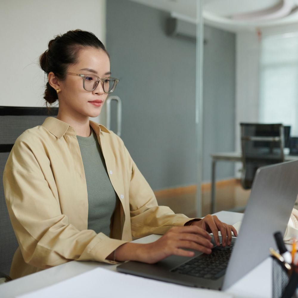 A young entrepreneur plans her business using her laptop