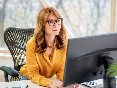 female bookkeeper gazes intensely at computer screen