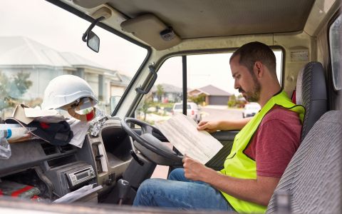 business owner deals with paperwork in pickup truck