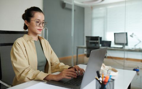 A young entrepreneur plans her business using her laptop