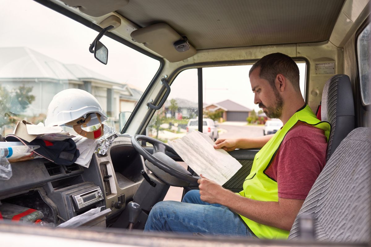 business owner deals with paperwork in pickup truck
