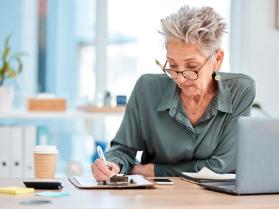 senior businesswoman in office calculates business value